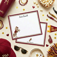 Load image into Gallery viewer, various items related to football and college sports, including a football, popcorn, a mug, a hat, and a note card with a horse image.
