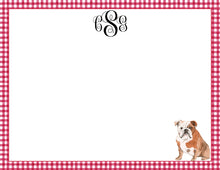 Load image into Gallery viewer, a brown and white bulldog sitting on the right side of a red and white checkered border.
