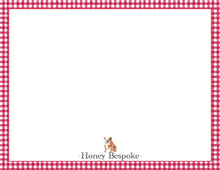 Load image into Gallery viewer, a small brown and white bulldog sitting in the center of a red and white checkered border.
